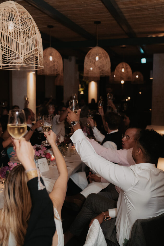The wedding party toasting at their wedding at Cafe Reitschule by Munich photographer Stories by Toni
