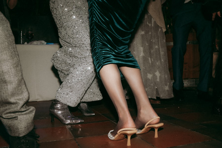 A wedding party detail photo of someone's shoes on the dance floor